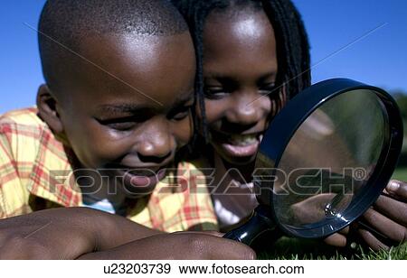 Children using a magnifying glass View Large Photo Image Stock Photo - Children using a magnifying glass. Fotosearch