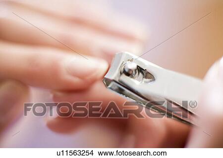 Picture - Clipping nails. Fotosearch