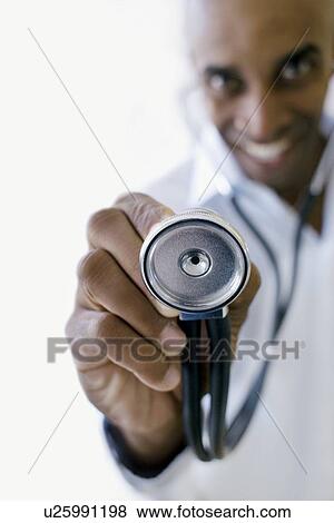 Stock Photo - Doctor holding a stethoscope. Fotosearch