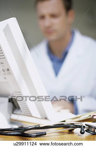 Picture - Doctor typing notes. Fotosearch