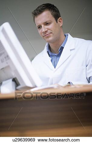 Stock Photo - Doctor typing notes. Fotosearch