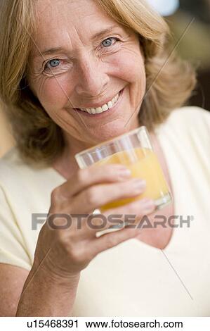 Drinking orange juice View Large Photo Image Stock Image - Drinking orange juice. Fotosearch