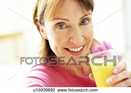 Drinking orange juice View Large Photo Image Stock Image - Drinking orange juice. Fotosearch