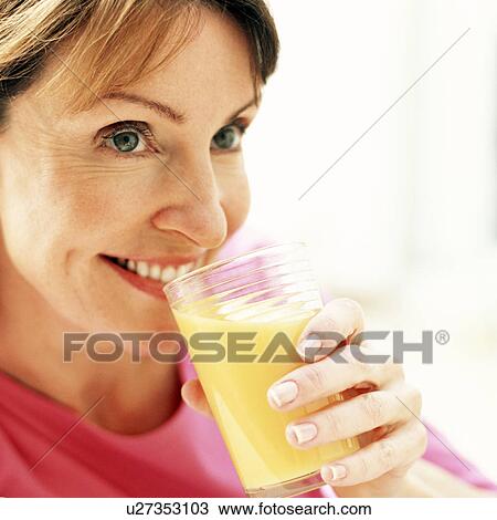 Drinking orange juice View Large Photo Image Stock Image - Drinking orange juice. Fotosearch