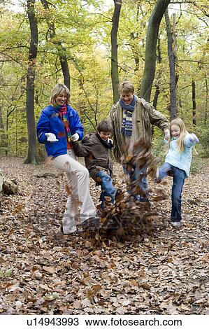 Family playing in a wood View Large Photo Image Stock Image - Family playing in a wood. Fotosearch