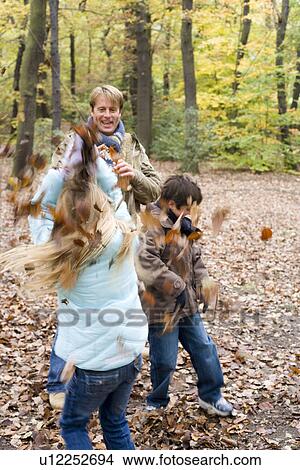Father and children playing in a wood View Large Photo Image Picture - Father and children playing in a wood. Fotosearch