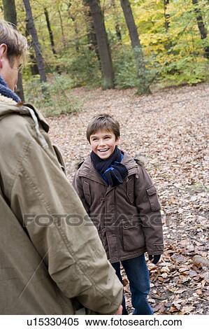 Stock Photography - Father and son in a wood. Fotosearch