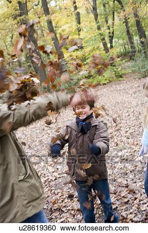 Father and son playing in a wood View Large Photo Image Stock Image - Father and son playing in a wood. Fotosearch