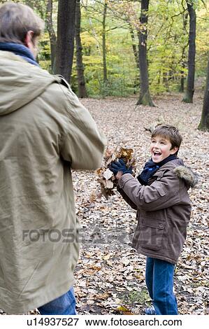Stock Photo - Father and son playing in a wood. Fotosearch