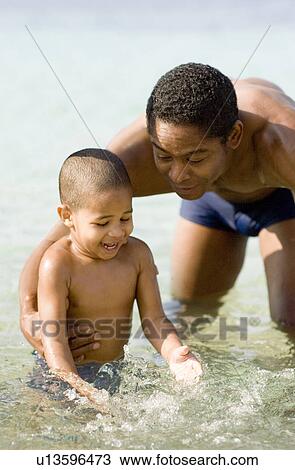 Stock Image - Father and son playing. Fotosearch