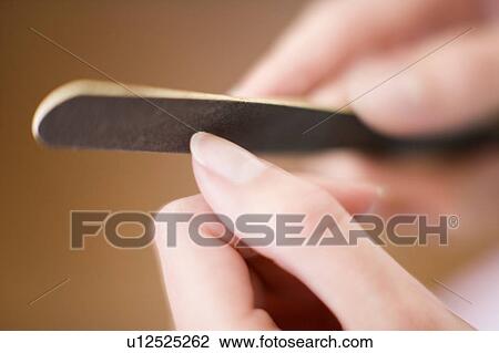 Stock Image - Filing nails. Fotosearch