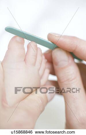 Stock Photograph - Filing toenails. Fotosearch