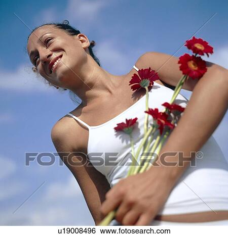Flowers held by happy woman View Large Photo Image Stock Photograph - Flowers held by happy woman. Fotosearch