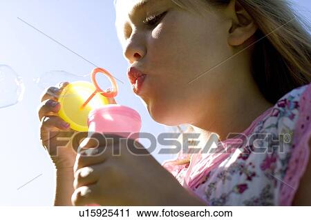 Girl blowing soap bubbles View Large Photo Image Stock Image - Girl blowing soap bubbles. Fotosearch