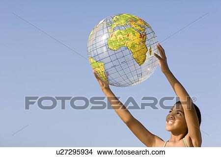 Picture - Girl holding an inflated globe. Fotosearch