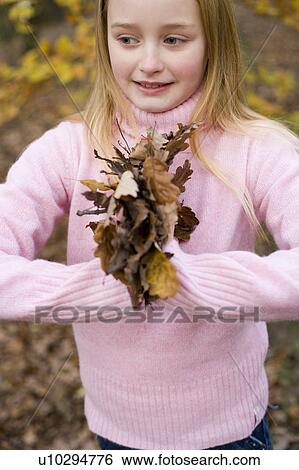 Girl holding autumn leaves View Large Photo Image Stock Photograph - Girl holding autumn leaves. Fotosearch