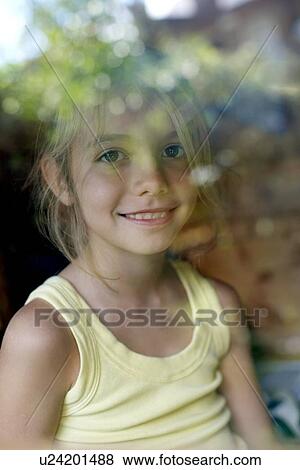 Stock Photo - Girl playing in a Wendy house. Fotosearch