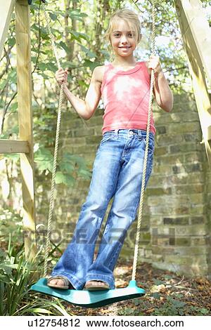 Girl playing on a swing View Large Photo Image Stock Image - Girl playing on a swing. Fotosearch