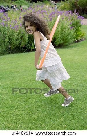 Picture - Girl playing with a hula hoop. Fotosearch