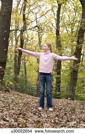 Girl playing with autumn leaves View Large Photo Image Picture - Girl playing with autumn leaves. Fotosearch
