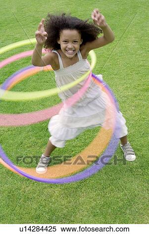 Girl playing with hula hoops View Large Photo Image Stock Photography - Girl playing with hula hoops. Fotosearch