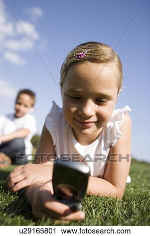 Girl using a mobile phone View Large Photo Image Stock Image - Girl using a mobile phone. Fotosearch