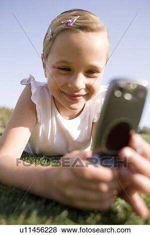 Stock Photo - Girl using a mobile phone. Fotosearch