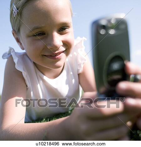 Stock Photograph - Girl using a mobile phone. Fotosearch