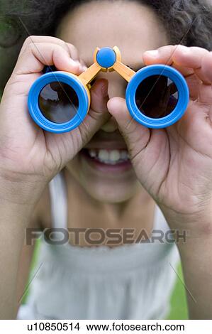 Picture - Girl using binoculars. Fotosearch