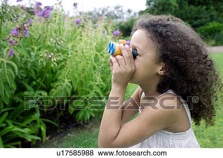 Stock Photo - Girl using binoculars. Fotosearch