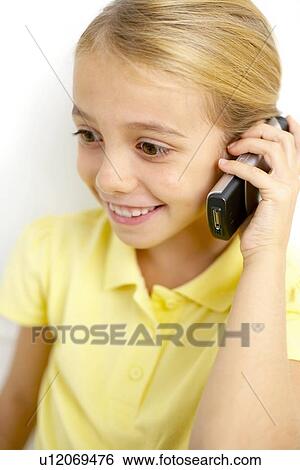 Girl using mobile phone View Large Photo Image Stock Photograph - Girl using mobile phone. Fotosearch