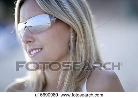 Stock Image - Girl wearing sunglasses. Fotosearch