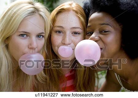 Stock Photo - Girls blowing bubblegum. Fotosearch