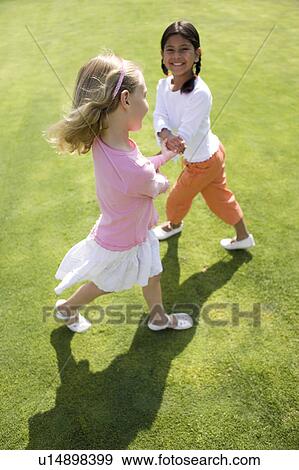 Stock Photo - Girls playing. Fotosearch