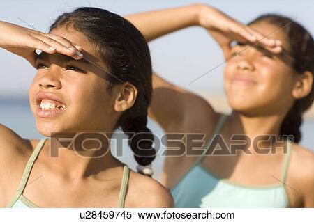 Girls shading their eyes View Large Photo Image Stock Photography - Girls shading their eyes. Fotosearch