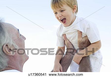 Grandfather lifting his grandson View Large Photo Image Stock Image - Grandfather lifting his grandson. Fotosearch