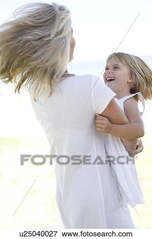 Stock Photo - Grandmother embracing her granddaughter. Fotosearch