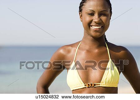 Stock Image - Happy woman on a beach. Fotosearch