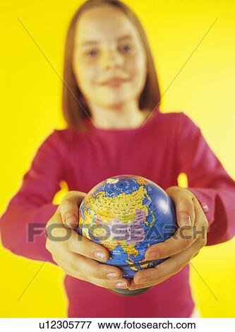 Holding a globe View Large Photo Image Stock Photo - Holding a globe. Fotosearch