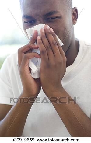Man blowing his nose View Large Photo Image Stock Photo - Man blowing his nose. Fotosearch