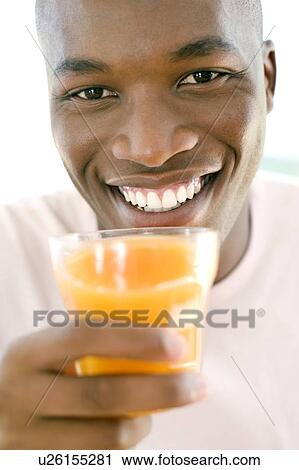 Man drinking orange juice View Large Photo Image Stock Image - Man drinking orange juice. Fotosearch