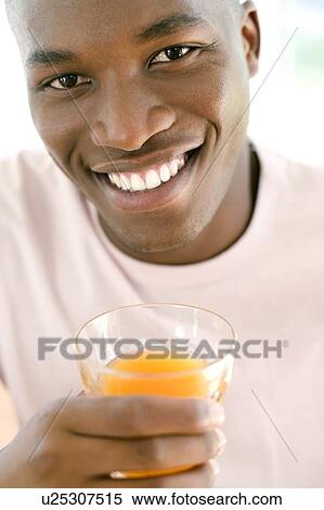 Man drinking orange juice View Large Photo Image Stock Photography - Man drinking orange juice. Fotosearch