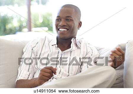 Man holding a pair of glasses View Large Photo Image Picture - Man holding a pair of glasses. Fotosearch