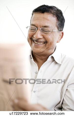 Man reading a newspaper View Large Photo Image Stock Image - Man reading a newspaper. Fotosearch