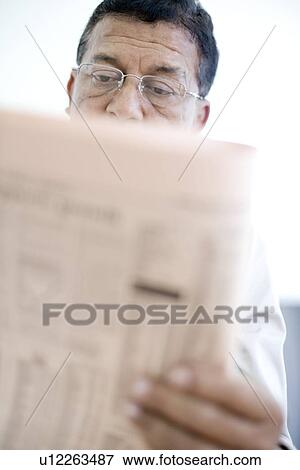 Man reading a newspaper View Large Photo Image Stock Photo - Man reading a newspaper. Fotosearch