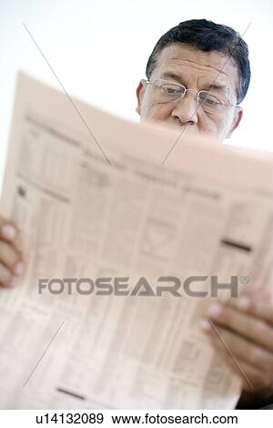 Man reading a newspaper View Large Photo Image Stock Photo - Man reading a newspaper. Fotosearch