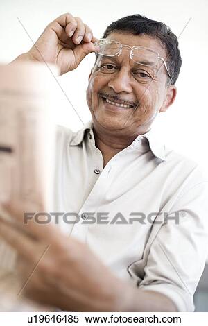 Man reading a newspaper View Large Photo Image Stock Photography - Man reading a newspaper. Fotosearch