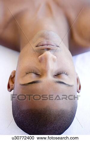 Stock Image - Man relaxing at a spa. Fotosearch