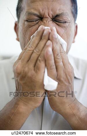 Picture - Man sneezing. Fotosearch