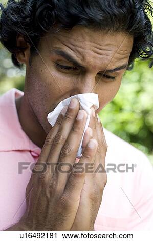 Stock Image - Man sneezing. Fotosearch